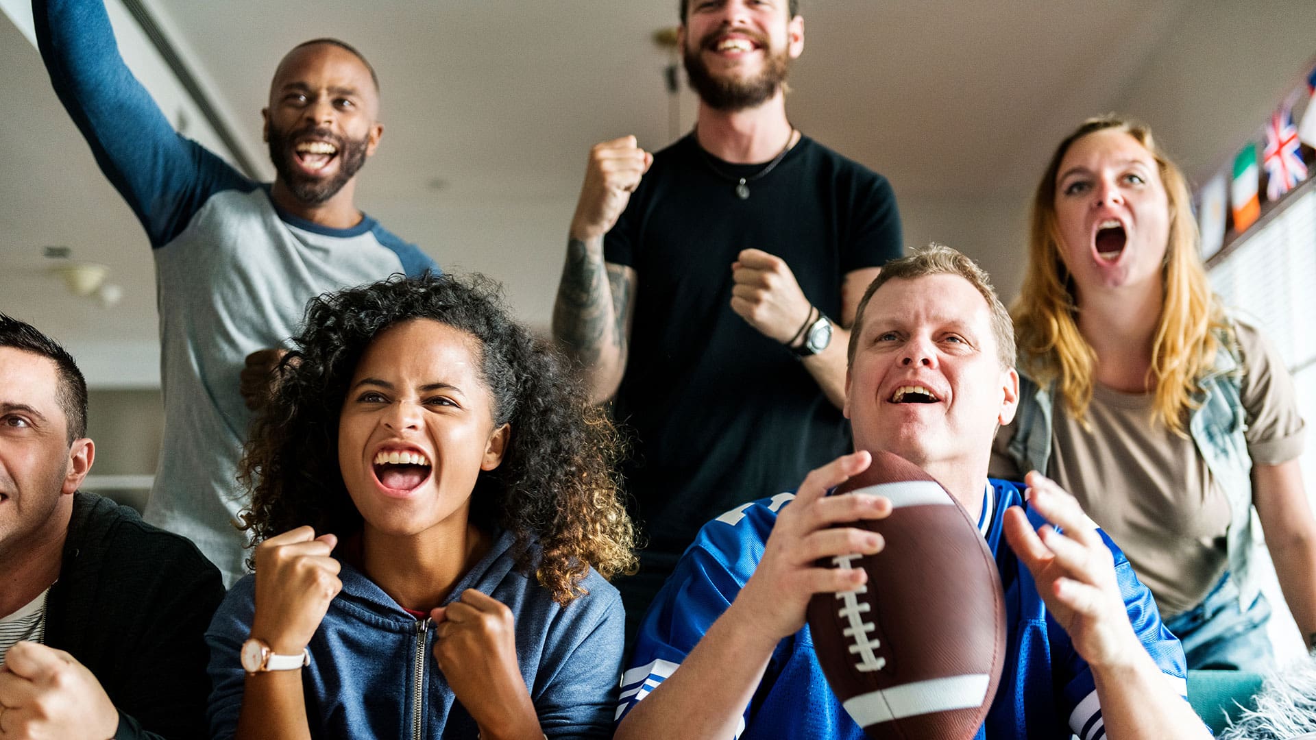 People cheering while watching the Super Bowl